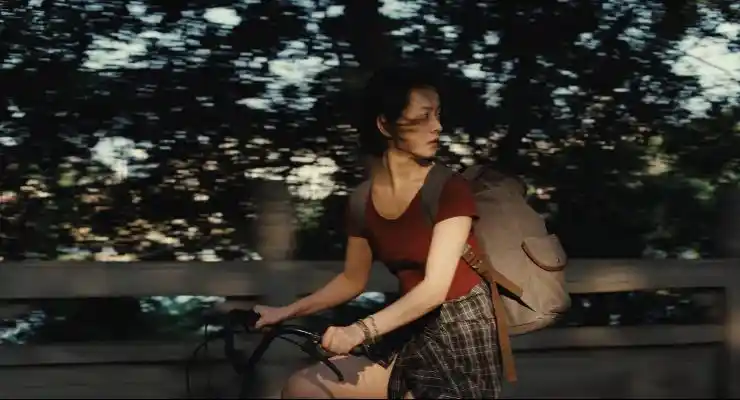 A girl rides her bike in forest area in A Girl Unknown.