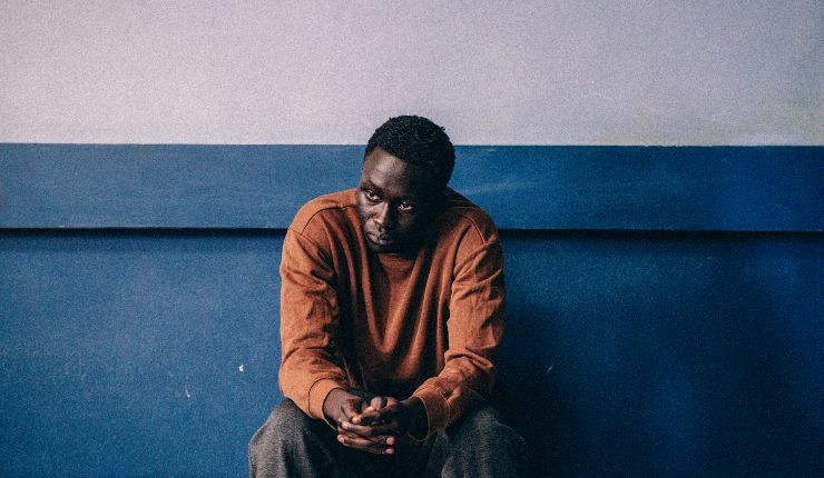 A young man sits reflecting in Animol
