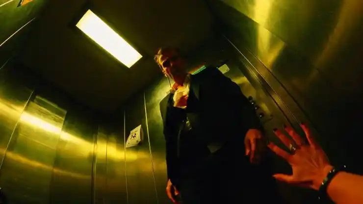 An angry man (John Hannah) looks down at someone in Bad Day At The Office
