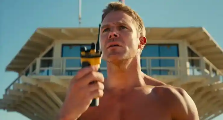 A man stands looking out to a beachwatch