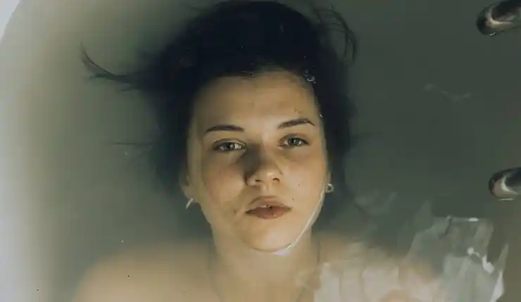 A young woman floats in water in Big Girls DOn't Cry