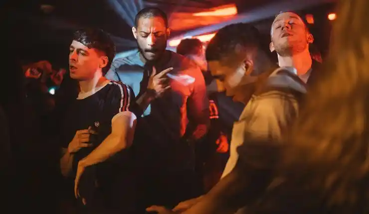 A group of young friends party together, in Clio Barnard's latest drama
