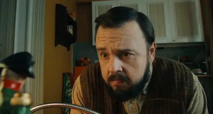 A bearded man looks concerned in Merry Christmas Aubrey Flint