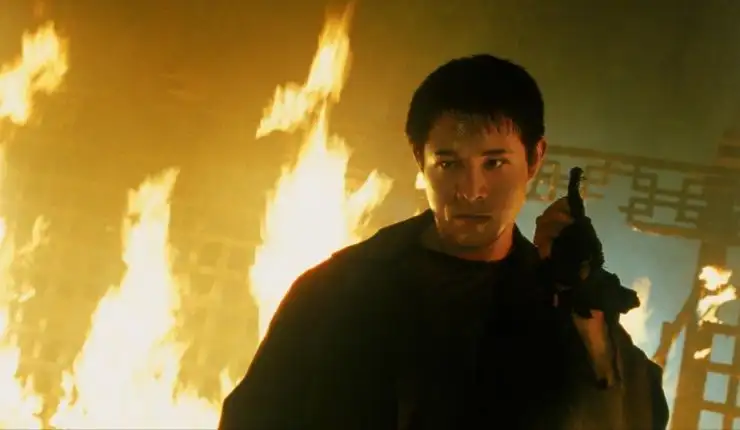 An Chinese man armed walking past fire