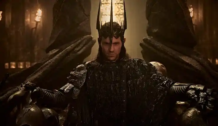 Lord Sauron sits on his thrown and his crown in The Rings Of Power