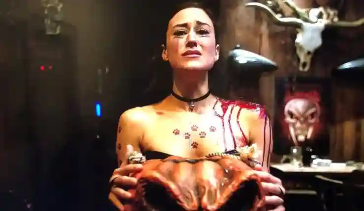 A woman looks terrified holding a orange skull in Tricks and Treats