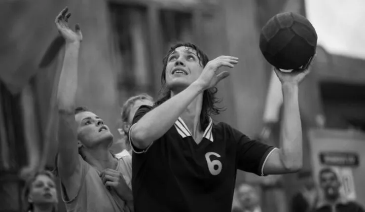A woman with a ball playing sports